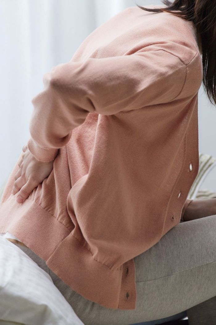 Woman having back pain due to osteoporosis after hysterectomy