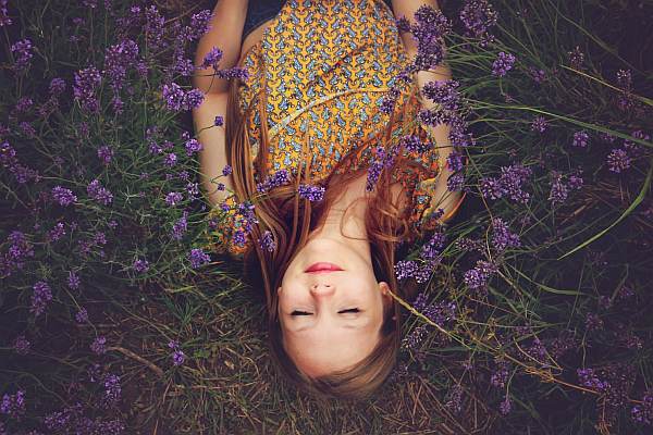 Woman sleeping in a field with lavender