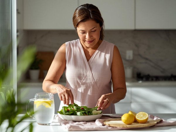 Woman preparing food in her kitchen for her post hysterectomy diet plan
